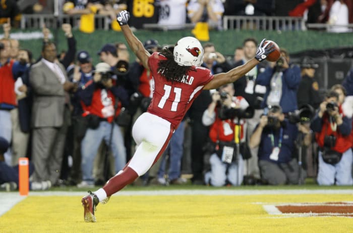 Cardinals receiver Larry Fitzgerald celebrates after scoring a touchdown.The long-time star has been a part of some of the greatest wins in franchise history.